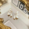 Oorbellen met witte kristallen: the white Crystal leaves