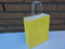Papieren koordtas geel 50 stuks 18x8x22cm / papieren tasjes