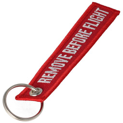 Pendant with the lettering Remove before flight Mini, dimensions approx. 10.9 x 2.2 cm