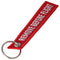 Pendant with the lettering Remove before flight Mini, dimensions approx. 10.9 x 2.2 cm