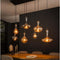 Hanglamp van 7 Karaf Lampen - Amber/Zwart - Artic Black Finish - Glas - Woonkamer - Keuken - Hanglamp - In Hoogte Verstelbaar tot 150 cm - Exclusief Lichtbron - Voedingstype Netstroom